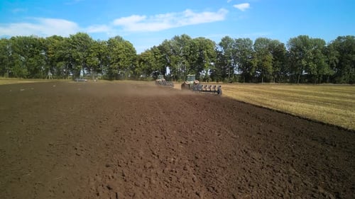 Tractors plowing the field in Ukraine