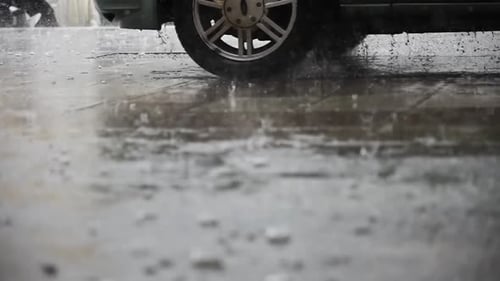 Rain on the Road Where a Car Passes