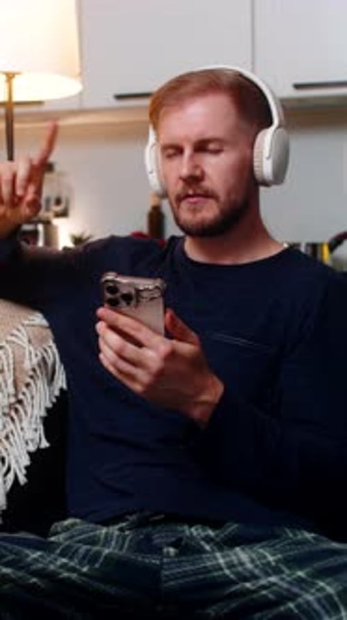 Man Listening to Music on Phone at Home