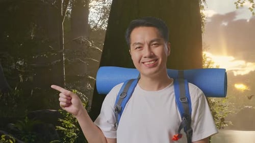 Close Up Of Asian Male Smiling And Pointing To Side While Exploring Nature