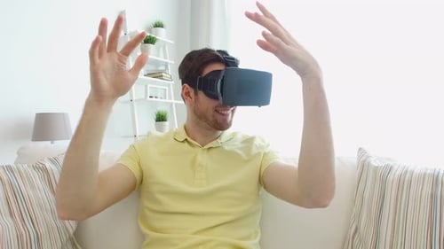 Man Using Virtual Reality Headset on Sofa