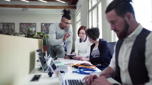 Young business team brainstorming startup ideas in a modern office space