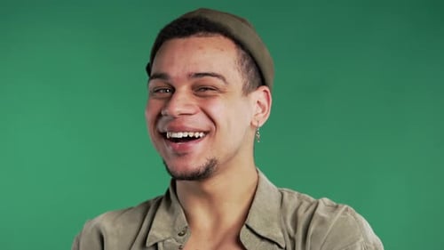 Young Man Laughing in Front of Green Screen