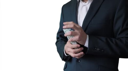 Man in Suit Counts and Puts Away Money