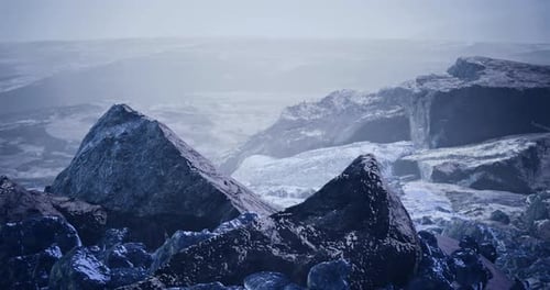 Stark Landscape Featuring Rugged Rock Formations Under Subdued Lighting
