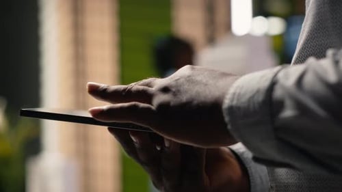 African American Developer Evaluating 3D Models Blueprints and Digital Software