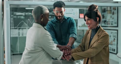 Team Stacks Hands and Celebrates in Modern Office