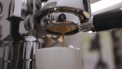 Espresso Machine Pouring Coffee in a Mug