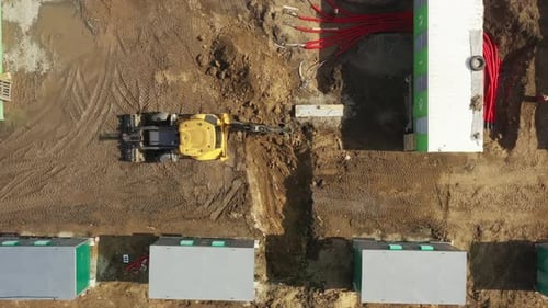 Backhoe Digger Excavates Construction Site From Above