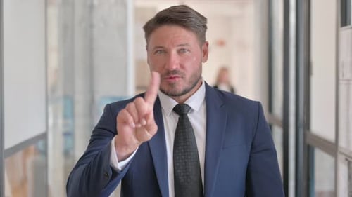 Portrait of Displeased Middle Aged Businessman Denying Offer