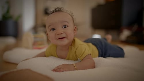 Happy Baby Lying on Blanket Indoors
