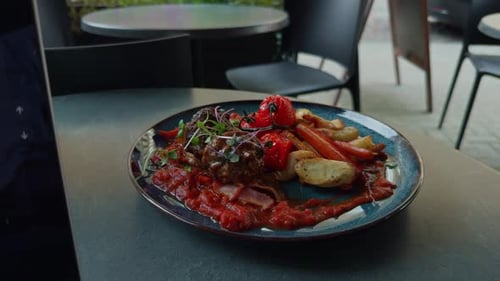 Delicious Plated Meal with Red Sauce at Restaurant
