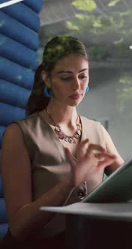 Tablet, online and woman in office cubicle for research, article review and editing report