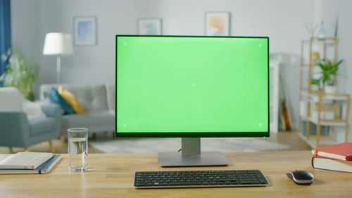 Personal Computer with Mock-up Green Screen Display Standing on the Desk in the Cozy Home Office Li