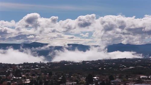 Beautiful Fluffy White Clouds Over Soft Foggy Mountain Valley Town
