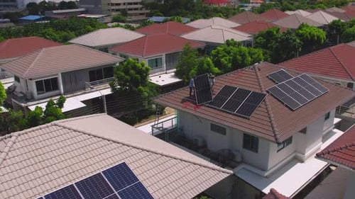 Drone view of engineer worker installed solar panels on roof of house.