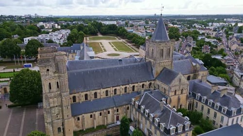 Receding aerial movement from the Ladies Abbey of Sainte-Trinité with Michel D'Ornano park, Caen, Fr