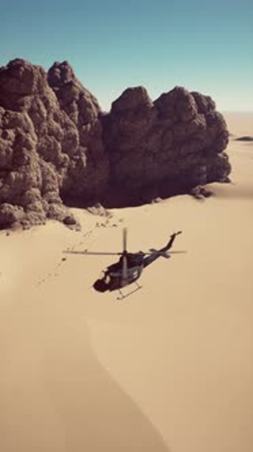 Military Helicopter Flying Over Desert Landscape