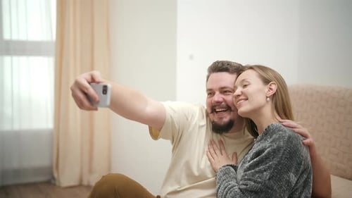 Happy Couple Smiling and Taking Selfie at Home