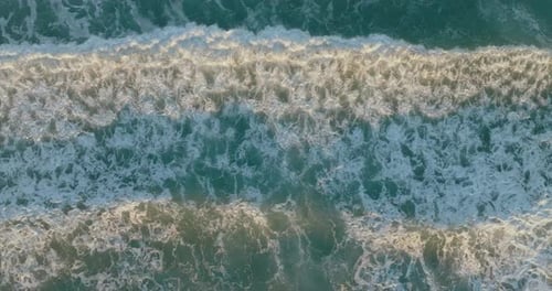 Aerial view of the sunsets over sea. Beautiful sea waves.