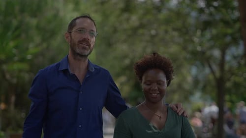 Couple Smiling and Walking Through an Urban Park