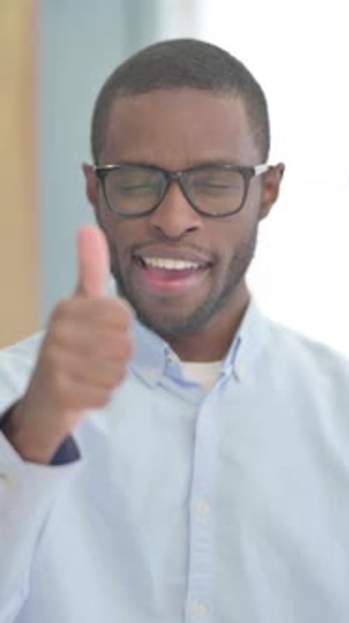 Man With Glasses Giving a Thumbs Up