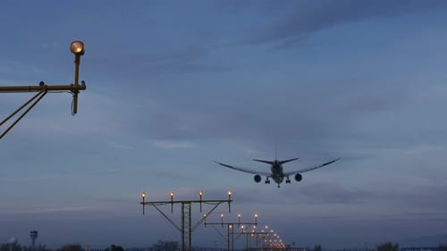 Plane Landing on Runway at Night