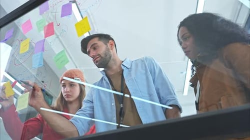 Diverse Team Brainstorms Strategy with Sticky Notes