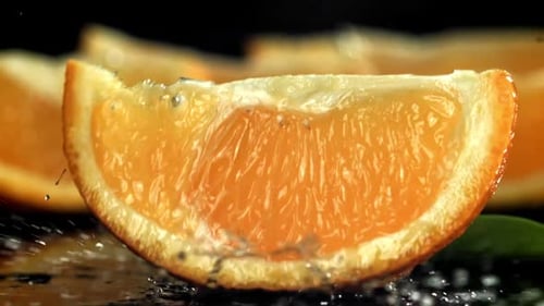Sliced Orange Slices Fall on the Table Filmed on a Highspeed Camera at 1000 Fps