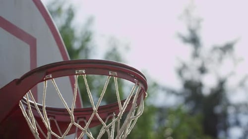 One on One Street Basketball; Closeup of Ball Going Into Basket Action