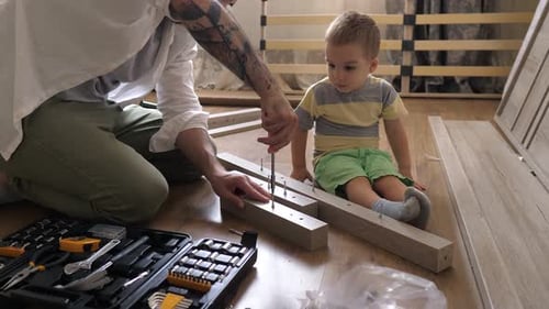 Father and Son Assembling Furniture at Home