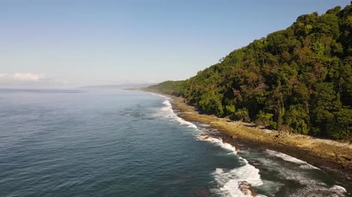 Zoom in aerial shot flying towards the coast