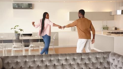 Happy Couple Dancing and Twirling in Apartment