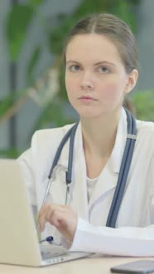 Woman Doctor Works at Laptop in Hospital Office