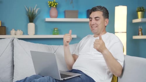 Man Clapping and Giving Thumbs Up on Laptop