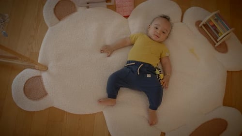 Happy Infant Lying on a Teddy Bear Rug