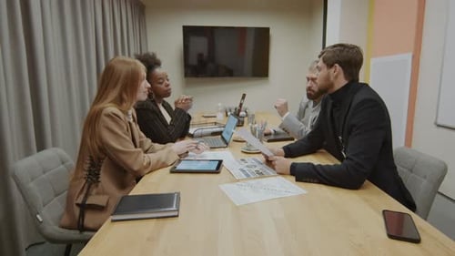 Business Colleagues Meet at Conference Table