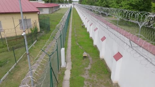 Medium Aerial Shot of Prison Fence Line
