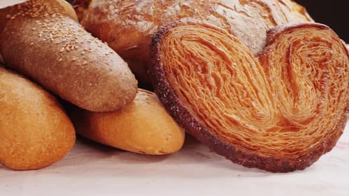 Bread Displayed By the Baker Assortment of Spanish Baguette and Traditional Bakery Shop Desserts
