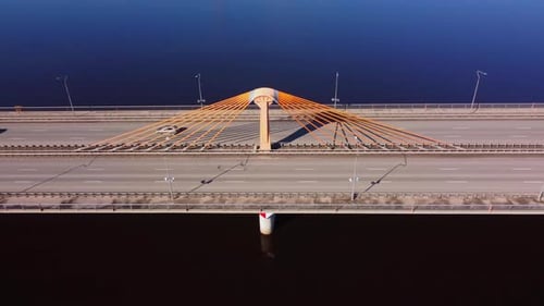 Top down aerial drone shot of cars driving on a bridge over a river. Southern bridge in the capital