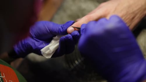 Closeup Top View Cutting Cuticle on Male Finger in Slow Motion Indoors Closeup Unrecognizable Female