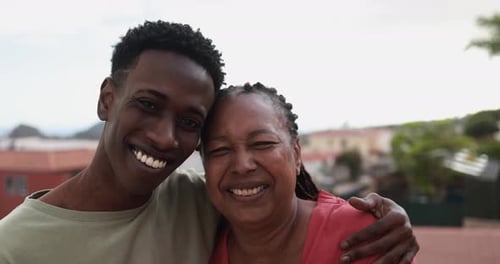 Smiling Man and Woman Embrace Outdoors in City