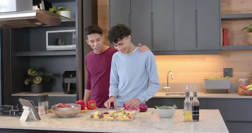 Young Adults Cooking Together in Modern Kitchen