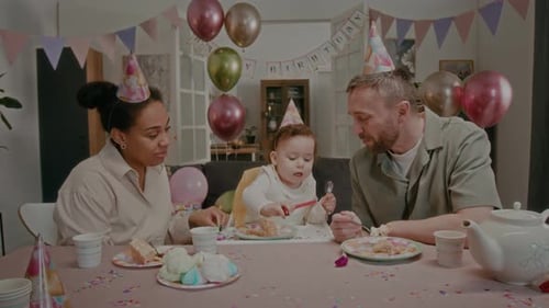 Family Celebrates Toddler's Birthday Together Indoors