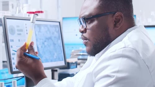 Scientist examining test tube in laboratory setting
