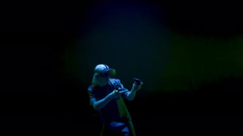 Adult Using VR Headset and Controllers