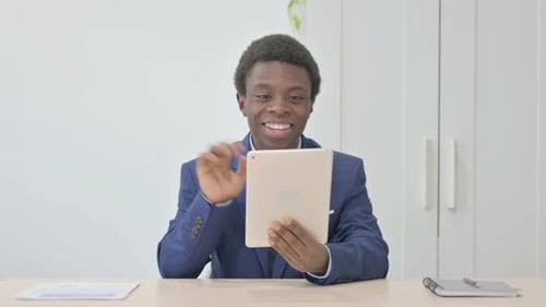 Young Adult on Tablet Video Call in Office