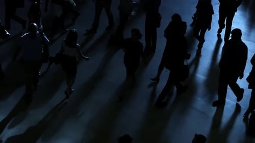 establishing shot of rush hour commuters walking in the city