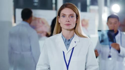 Focused Woman Doctor in Hospital with Colleagues