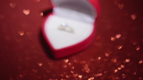 Engagement Ring in Heart-Shaped Box with Bokeh Hearts